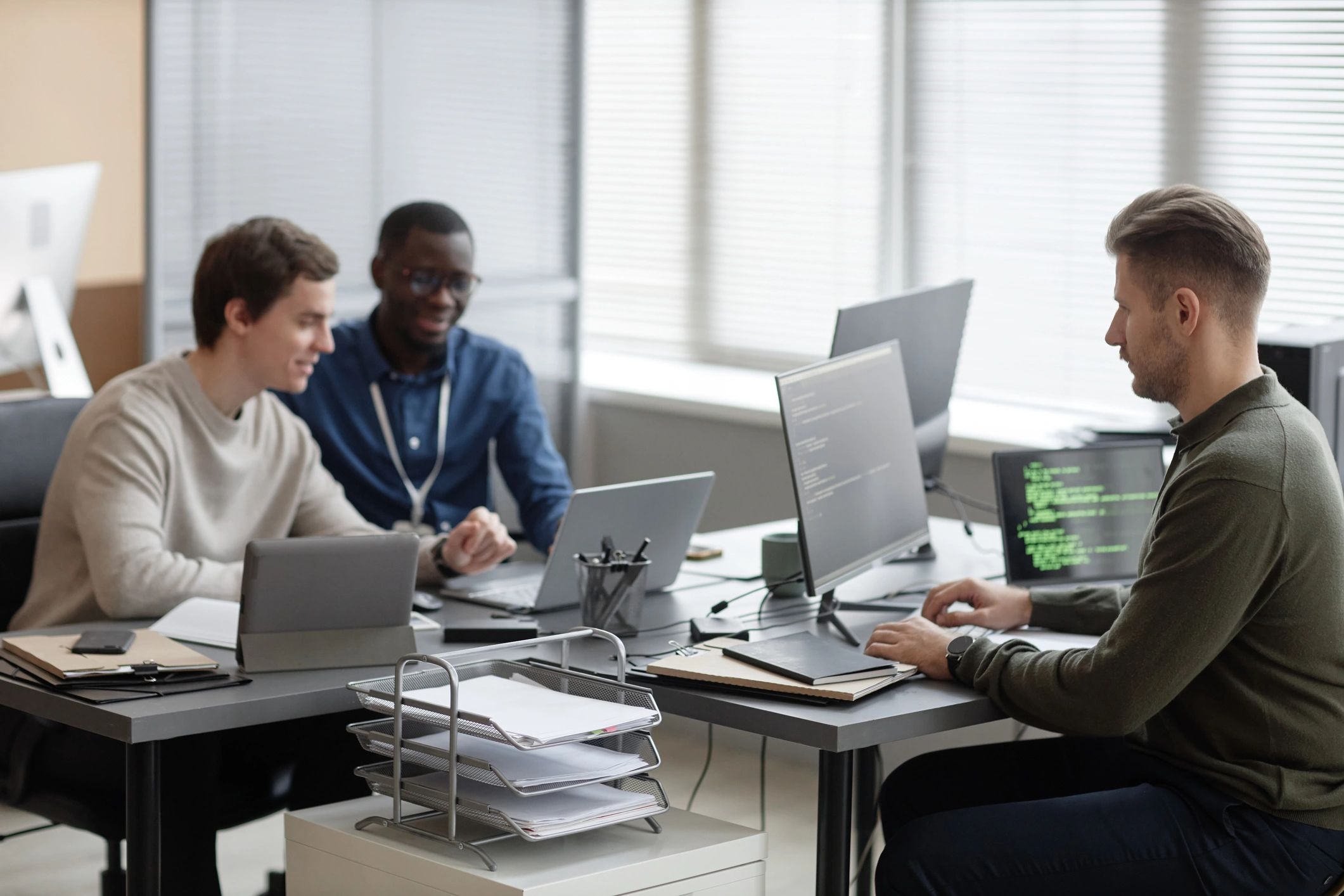 Programmers working in a modern office on a cybersecurity project